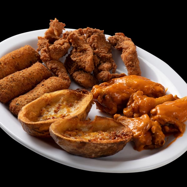 A pub platter with crispy chicken tenders, mozzarella sticks, potato skins, and buffalo wings.