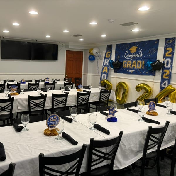 Town Pub dining room set up for a graduation party with "Congrats Grad" banners and 2024 balloons.