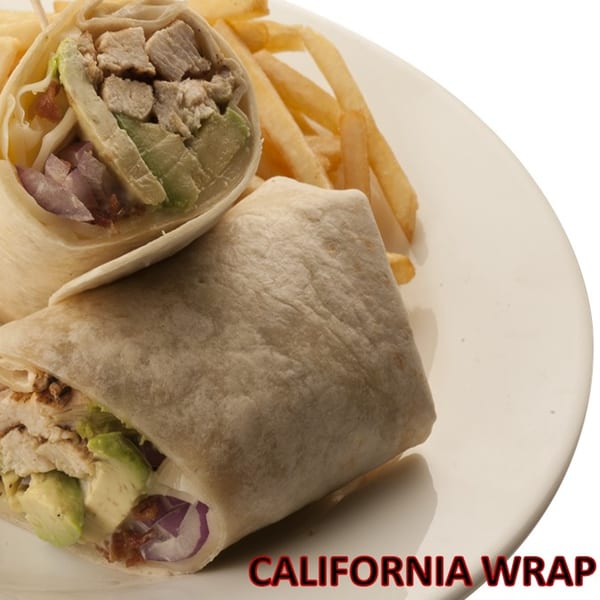 Two California wraps, filled with chicken, avocado, and red onion, served with fries on a white plate.