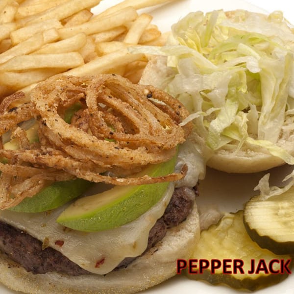 Pepper Jack burger with avocado, crispy onion rings, fries, shredded lettuce, and pickles.