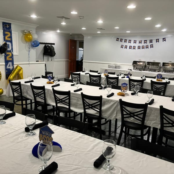 A private dining room at Town Pub set up for a graduation party with long tables and buffet.