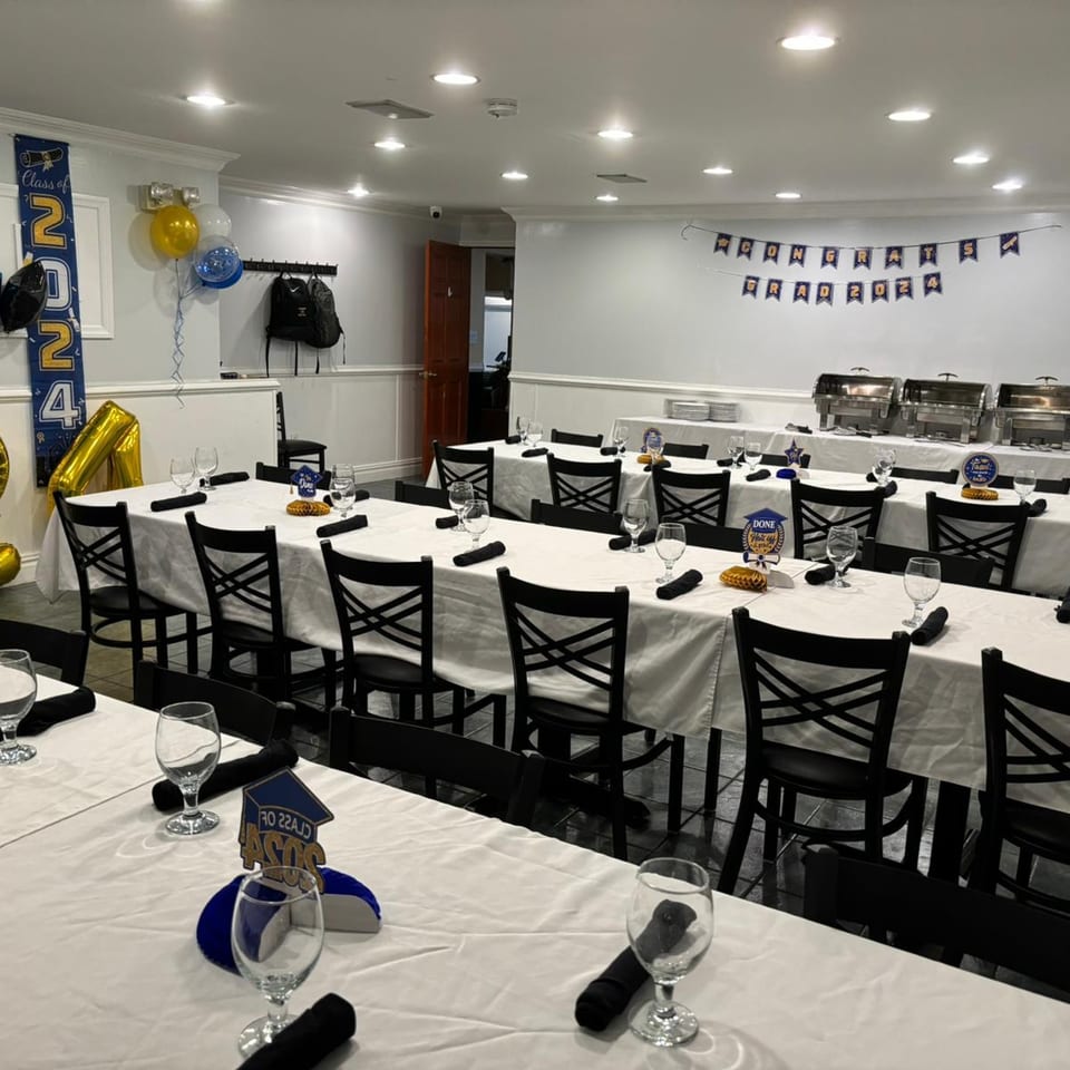 A private dining room at Town Pub set up for a graduation party with long tables and buffet.