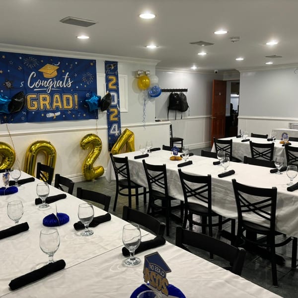 A Town Pub dining room set up for a graduation party with "Congrats Grad" banners and 2024 balloons.